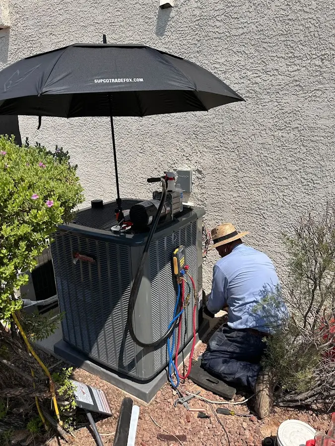 HVAC technician performing outdoor AC maintenance in Kingsland